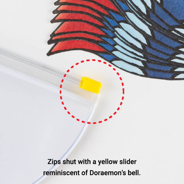 Zips shut with a yellow slider reminiscent of Doraemon’s bell.
